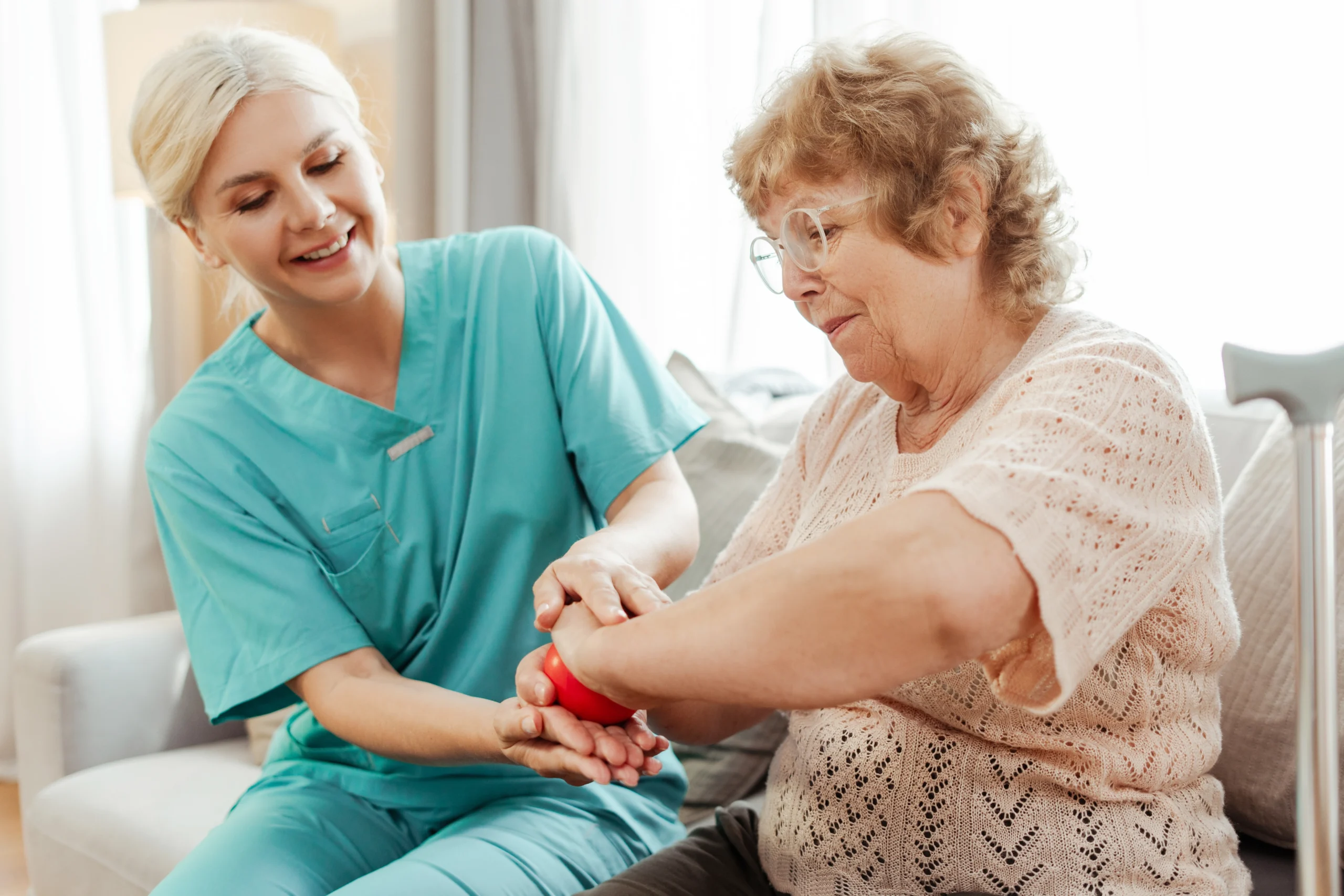 young blonde caregiver does physical taining with elder woman
